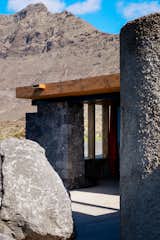 Entry hallway of stone home with wood roof in Lanzarote, Canary Islands with mountain in the background