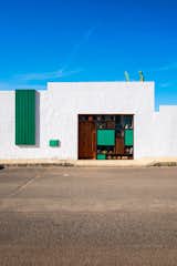 Exterior view of white face with rectangular green wood highlights reminiscent of a Mondrian painting