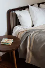 “We worked with Maine-based Chilton Furniture on a lot of custom pieces,” the couple say. Pictured here are the Dune bed in walnut and a Mysa nightstand.