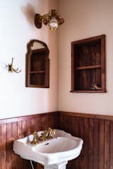 The vintage mirror complements a caged sconce from Portland Architectural Salvage.