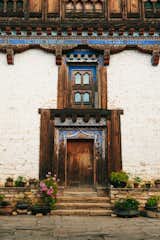 Ornate and aging brick and wood facade of utse central tower fortress in Ogyen Choling, Bhutan