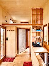 After months of waiting for approvals to build a house in Sintra, Portugal, artist Chris Saunders decided to pivot, commissioning a custom tiny home on wheels from architecture studio Madeiguincho. The 200-square-foot house, with its honey-colored wood cladding and contrasting blond wood interior, suits Chris perfectly. “Since moving here I’ve simplified not only my way of living, but also my mentality and work ethic,” he says.