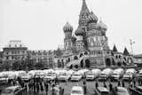 Black-and-white photograph of row of pick-up trucks towing Airstreams parked in Red Square, Moscow in 1964