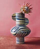 Flower in blue and white striped Profumo Vase by Henry Holland photographed with pink backdrop