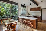 The airy kitchen has tree house vibes, thanks to the thick surrounding foliage.&nbsp;