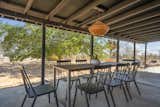 A large covered patio overlooks the Joshua Trees lining the backyard. "Overall, Mojave Modern is the ultimate place to unwind, kick back, and slow down,