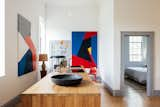 Soaring ceilings continue into the kitchen, which has a wooden island.