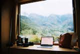 On Monday afternoon, I try out the counter seating that comes with a broad view of the mountains. You can open the window to let in a breeze on a warm day.  doug streeter’s Saves from One Night in a Tiny Cabin Designed for Remote Work in the Mountains of Southern California
