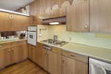 The kitchen still has its original custom cabinetry and Formica countertops.&nbsp;