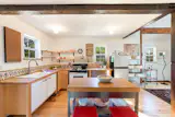 The detached barn is fitted with post-and-beam construction and comes with a light-filled, well-equipped kitchen.