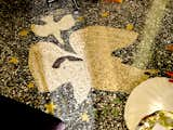 Detail of black, white, beige, green, and gold terrazzo flooring in the small detached office of Hollywood home.