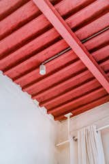Original wood beams near the entry are covered in Heirloom Rose.  Photo 8 of 14 in For Her First Renovation, a Mérida Designer Went “Mistake By Mistake”
