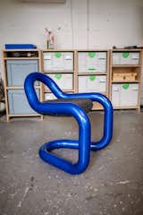 Chunky chair made of thick blue tube with charcoal, dark grey fabric seat by Andu Masebo.
