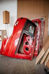 Red car doors lean against wall of Andu Masebo’s London workshop.