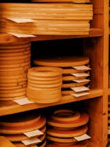 Wood disks are staked on shelves in Los Angeles workshop of Adi Goodrich, founder of Sing Thing.