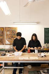 Aman Bhayana and Sugandhi Mehrotra of Stem Design stand at workbench in their Noida, India studio.