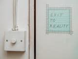 Sign reading Exit to Reality hangs on door of Tejumola Butler Adenuga’s London studio.