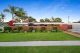 A long brick wall partially covers the front facade, enhancing the home's sense of privacy.  Photo 2 of 11 in John Lautner’s Legendary Alexander House Hits the Market for $3.4M