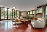 In the living room, 10-foot floor-to-ceiling glass doors open to one of the three terraces. The original red flooring pops against the neutral concrete-block walls and wooden trim.  Photo 3 of 10 in Here’s a Rare Opportunity to Buy Two Frank Lloyd Wright Homes for $4.5M