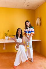 Longtime friends Deepica Mutyala and Natalie Ebel bask in the glow of Porsche Speed Yellow at the freshly-painted Live Tinted office.  Photo 3 of 8 in Makeup Entrepreneur Deepica Mutyala Embraces All Hues