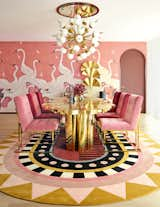 In the dining room of this Melbourne penthouse by&nbsp;Australian interior designer Greg Natale, pink Gucci Heron print wallpaper and maroon and brass accents set the tone for the vibrant palette.