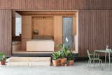 Flexible living space, kitchen, and bedroom with stowable murphy bed in Minima 1 CLT prefab prototype in Somersby, Australia, by Fabprefab and Trias Studio.