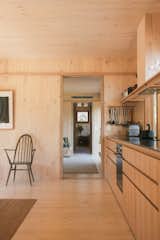 Kitchen with wood cabinetry in kit of parts Minima 1 CLT prefab home by Trias Studio and Fabprefab in Glen Davis NSW. 