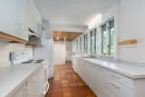 The bright and airy kitchen, located near the back of the home, has long countertops and plenty of storage.