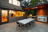A concrete patio with a covered grilling area caters to easy alfresco dining.