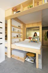 In addition to housing shelves and cabinets, the nook conceals a bed that drops down from the ceiling.