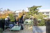 The planted rooftop on Cutwork’s modular prefab PolyRoom for Bouygues Immobilier with mint green custom outdoor furniture, concrete planters, and integrated irrigation.