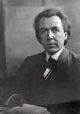 Black and white photograph portrait of young Frank Lloyd Wright.