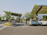 Parking lot with electric charging stations powered by solar array outside Tempe Micro Estates housing project in Tempe, Arizona, by coLAB Studio.