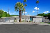 The renovated home sits on a spacious lot surrounded by thick hedges and dotted with soaring Palm trees, all while being just a short walk away from downtown Palm Springs.  Photo 1 of 8 in Asking $1.3M, This Palm Springs Midcentury Checks All the Retro Boxes
