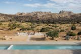 looking out over a pool and firepit to the mountains