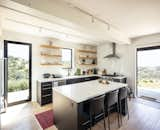 Kitchen of Connect Homes prefab prefabricated Designer Series home house in Santa Ynez, California, with floor-to-ceiling glass sliding windows.