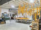 Strings of drying marigolds hang over the workspace in Blue Light Junction.