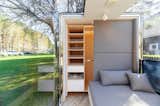 Interior of microHaus prefab ADU tiny home by Haus.me with ceramic flooring, wood millwork, and slide-out storage.