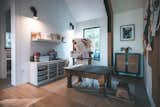 Children's playroom craft room with easel and art supplies and engineered hardwood floors in cedar-sided, glulam prefab prefabricated home by Blend Projects in British Columbia, Canada. 