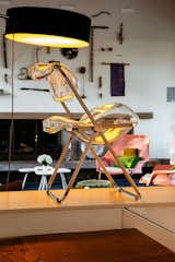 A chair sculpture made of chromed zinc and glass by Berlin-based artist Inga Danysz stands atop a ledge that divides the entry from the living room.