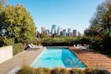 Although previous owners built a pool at a lower part of the yard near the piano room, the couple decided to build a new one just off the kitchen. “We thought, it would be amazing to have a pool that was kind of jutting out, with the backdrop of the city,” John says. The patio doubles as entertaining space for summer parties.