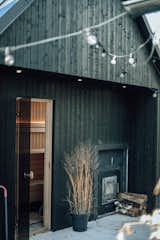 Prefab prefabricated My Galia wood-fired sauna by My Cabin with black stained spruce cladding.
