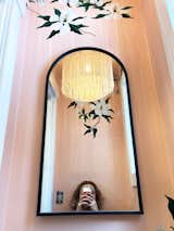 The powder room, featuring a hand-painted mural done by Bloom's mother and a custom light fixture, fabricated in Latvia and sourced from Etsy.  Photo 4 of 8 in How Designer Molly Bloom Enlisted Her Family to Renovate—Without Going Crazy