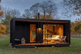 Konga M model cabin prefab prefabricated slim CLT cross-laminated timber cabin with charred black wood cladding.