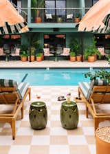 The interior color palette—a mix of peachy pinks and greens—continues to the pool area.