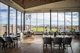 a restaurant dining room looking out on the colorado mesa campus - gray chairs surround square tables