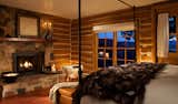 a room at brush creek ranch with a faux fur throw on the bed and fireplace