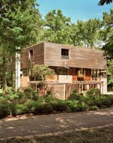Exterior of house in Palisades New York by Charles P Winter renovated by Rick Cook Fox CookFox with concrete, brick, and wood cladded walls. 