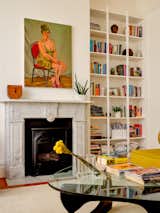 Aamer’s paintings hang throughout the apartment, including over the refurbished marble fireplace. Haddock considered Keith and Aamer’s book collection and designed sleek floor-to-ceiling shelving.