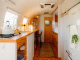 The couple added the wood finishes; the white surfaces are original. "We used construction-grade four by fours," says Riley, referencing the tiled offcuts that make up the trailer’s floor.